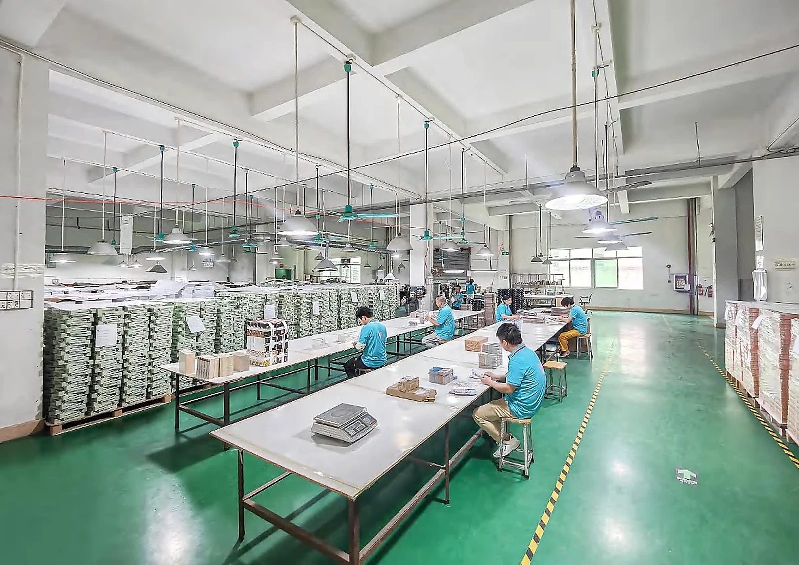 Company-supplied production-floor photo showing visible paper-product handling work